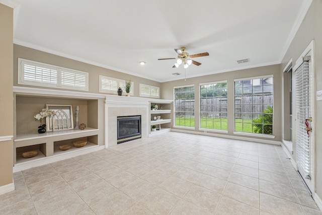 4210 Olive Oak Ct, Houston, TX 77059 - unfurnished living room with tile patterned floors, ornamental molding, a ceiling fan, built in shelves, and a tile fireplace