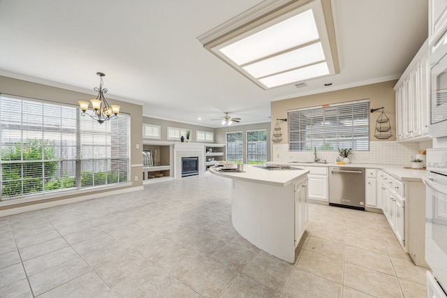 4210 Olive Oak Ct, Houston, TX 77059 - kitchen with dishwasher, a glass covered fireplace, light tile patterned flooring, a sink, and light countertops