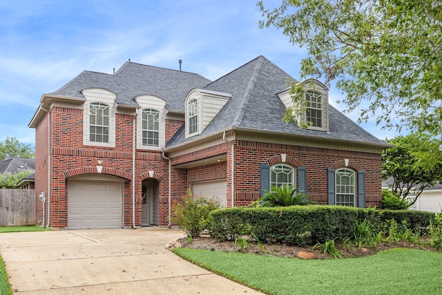 4210 Olive Oak Ct, Houston, TX 77059 - view of front facade featuring concrete driveway, brick siding, a shingled roof, and fence