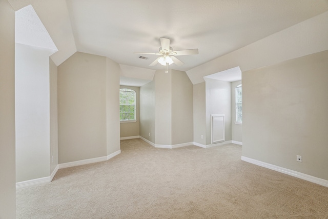 bonus room featuring light carpet, vaulted ceiling, and ceiling fan