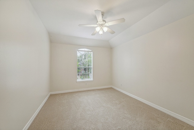 unfurnished room featuring vaulted ceiling, ceiling fan, and carpet floors