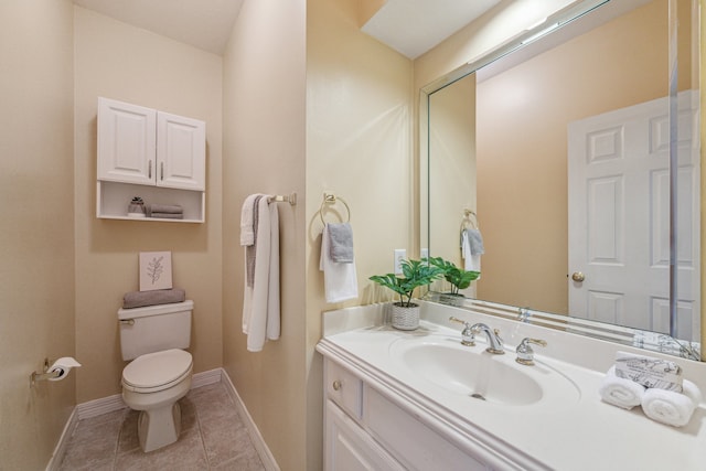 bathroom with vanity, tile patterned flooring, and toilet