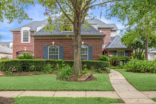 4210 Olive Oak Ct, Houston, TX 77059 - view of front of house with brick siding, roof with shingles, and a front yard