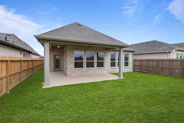 back of house featuring a yard and a patio area