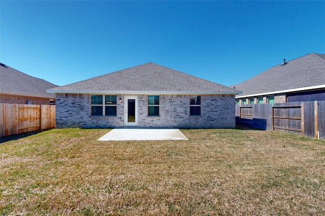 19910 Paros Island Dr, Hockley, TX 77447 - back of house with a patio area, a fenced backyard, brick siding, and a lawn