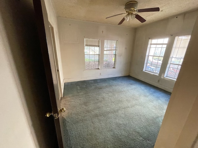 carpeted empty room with a textured ceiling and ceiling fan