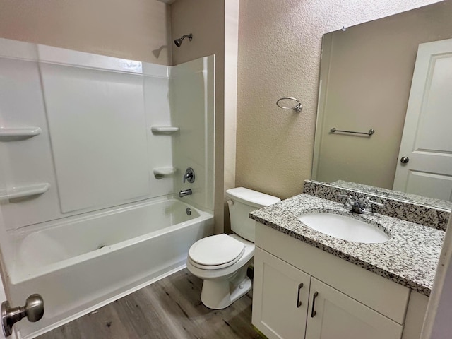 full bathroom with vanity, hardwood / wood-style floors, bathtub / shower combination, and toilet