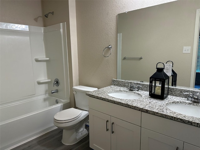 full bathroom featuring vanity, toilet, hardwood / wood-style floors, and shower / bathing tub combination