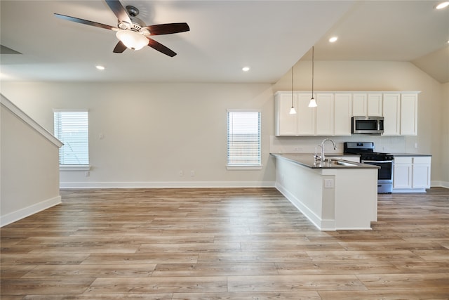 kitchen featuring sink, hanging light fixtures, kitchen peninsula, white cabinets, and appliances with stainless steel finishes