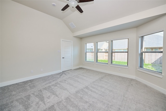 carpeted spare room with ceiling fan and lofted ceiling