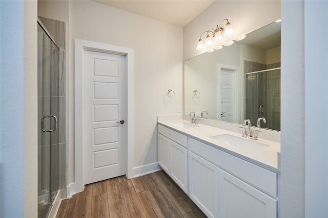 bathroom with hardwood / wood-style floors, vanity, and walk in shower