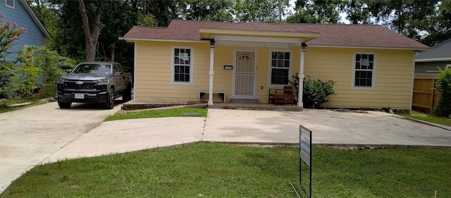 bungalow-style home with a front lawn