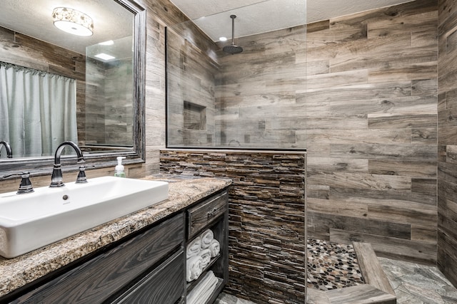 bathroom featuring tile walls and vanity