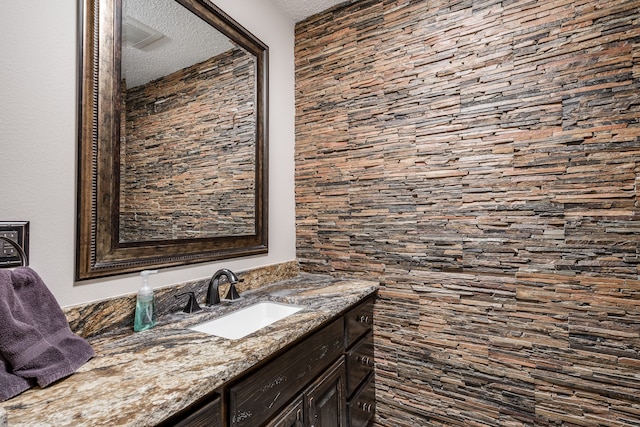 bathroom featuring vanity and a textured ceiling