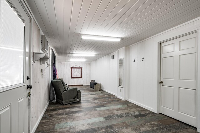 unfurnished room with dark hardwood / wood-style floors, wooden walls, and wooden ceiling