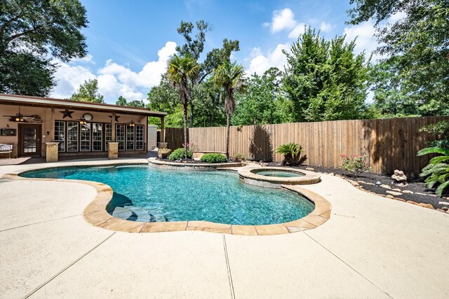 view of pool with an in ground hot tub, french doors, a patio area, and ceiling fan