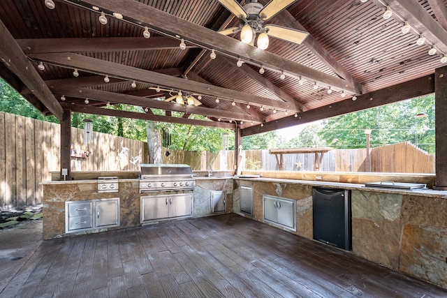 view of patio / terrace featuring a gazebo, ceiling fan, area for grilling, an outdoor kitchen, and a deck