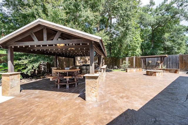 view of patio with a gazebo, an outdoor fire pit, and a grill