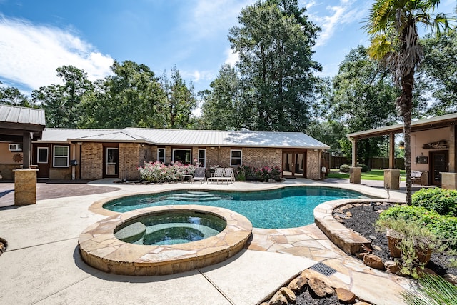 view of swimming pool with an in ground hot tub and a patio area