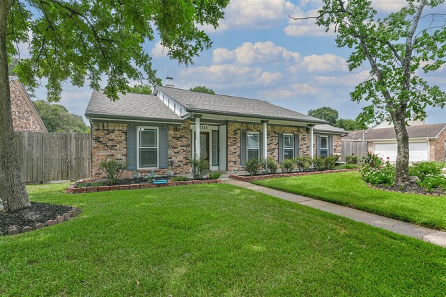 ranch-style home featuring a garage and a front yard