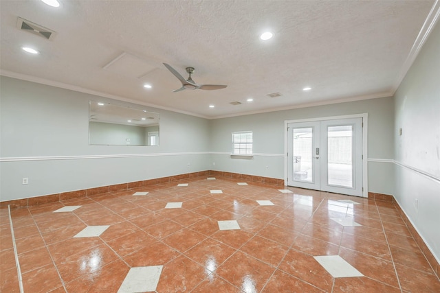 tiled empty room featuring a textured ceiling, visible vents, baseboards, french doors, and crown molding