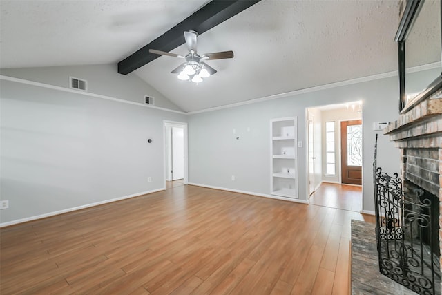 unfurnished living room with vaulted ceiling with beams, light wood-style floors, baseboards, and visible vents