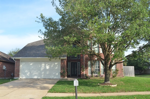 view of property hidden behind natural elements with a garage and a front yard