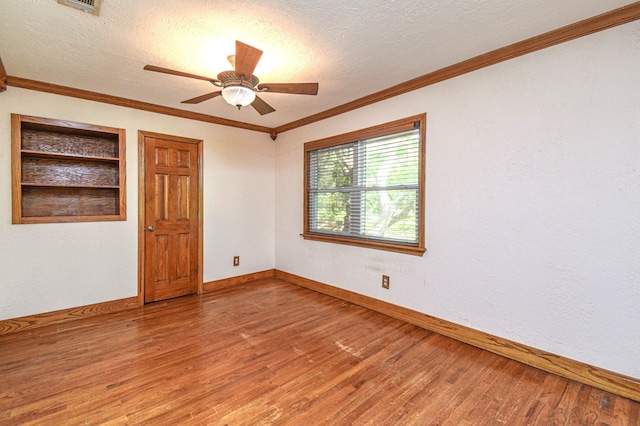 36920 Cougar Dr, Simonton, TX 77476 - unfurnished room with ornamental molding, wood finished floors, and a textured ceiling