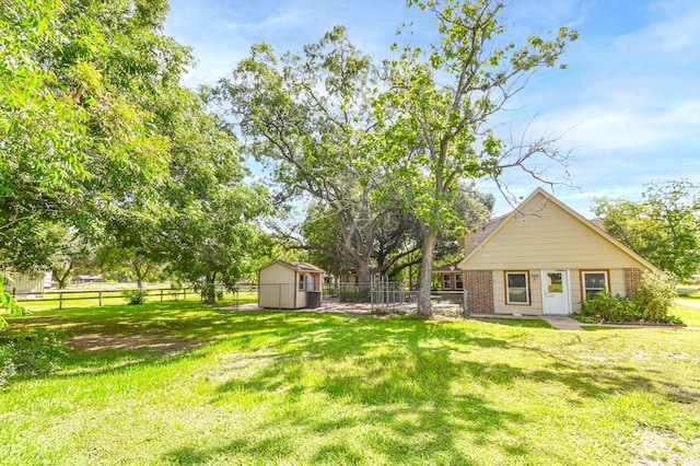 36920 Cougar Dr, Simonton, TX 77476 - view of yard with an outbuilding, a storage unit, and fence private yard