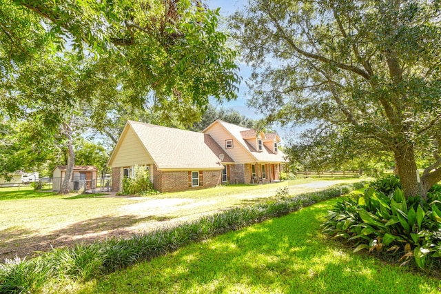 36920 Cougar Dr, Simonton, TX 77476 - view of front of property featuring a front lawn, fence, and brick siding