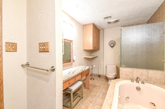 36920 Cougar Dr, Simonton, TX 77476 - bathroom with visible vents, toilet, a textured ceiling, tile patterned flooring, and a whirlpool tub