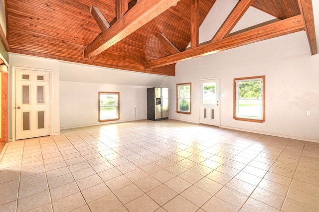 36920 Cougar Dr, Simonton, TX 77476 - unfurnished living room featuring beam ceiling, light tile patterned flooring, and plenty of natural light