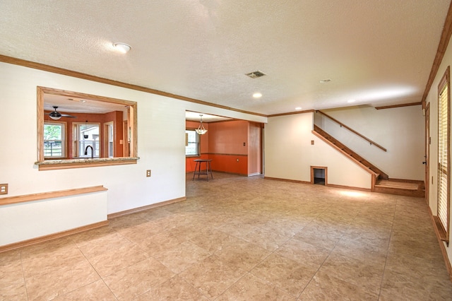 36920 Cougar Dr, Simonton, TX 77476 - unfurnished living room featuring a textured ceiling, stairs, visible vents, and ornamental molding