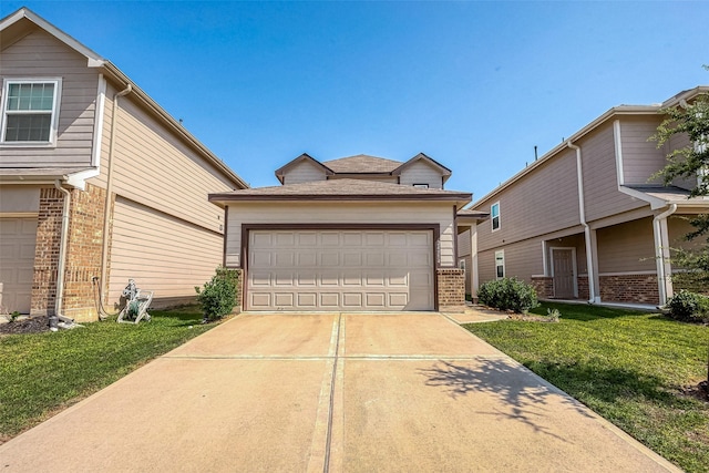 view of front of property featuring a garage and a front lawn