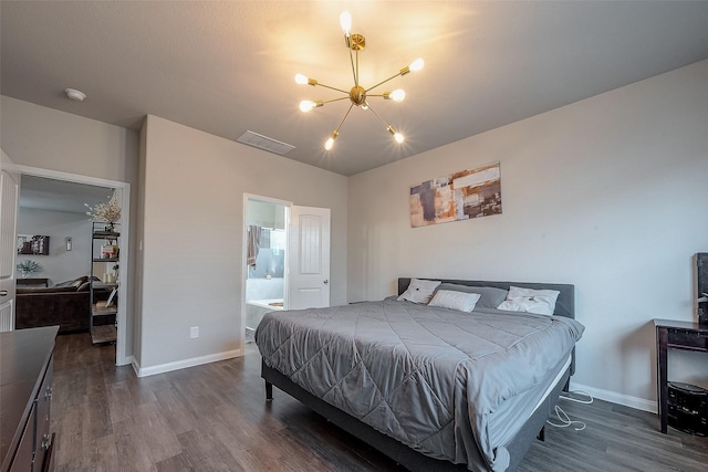 bedroom featuring dark wood-type flooring, connected bathroom, and an inviting chandelier