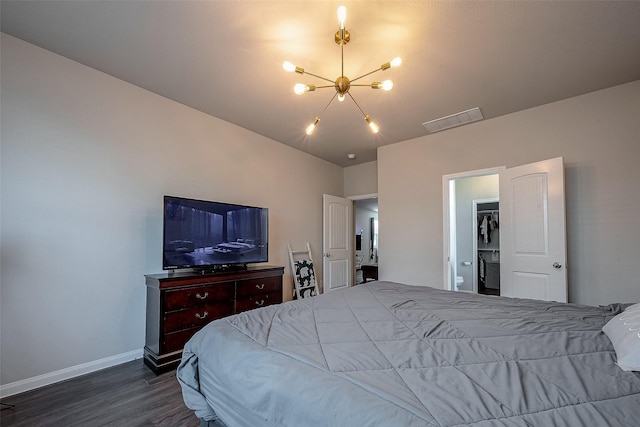 bedroom with dark hardwood / wood-style flooring and a notable chandelier