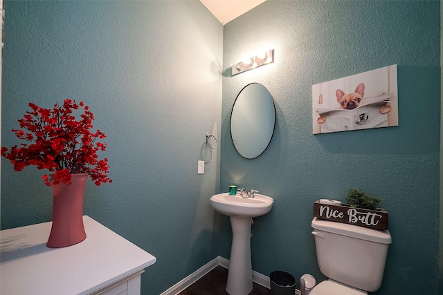 bathroom featuring toilet and sink