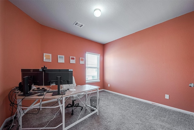 carpeted office featuring a textured ceiling