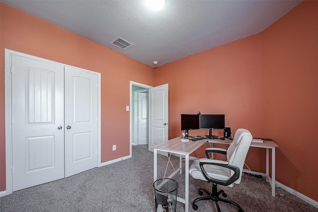 office space featuring dark carpet and a textured ceiling