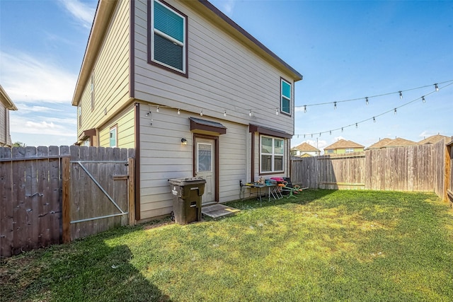 rear view of house featuring a lawn