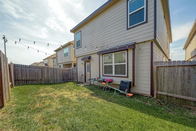 rear view of property with a lawn