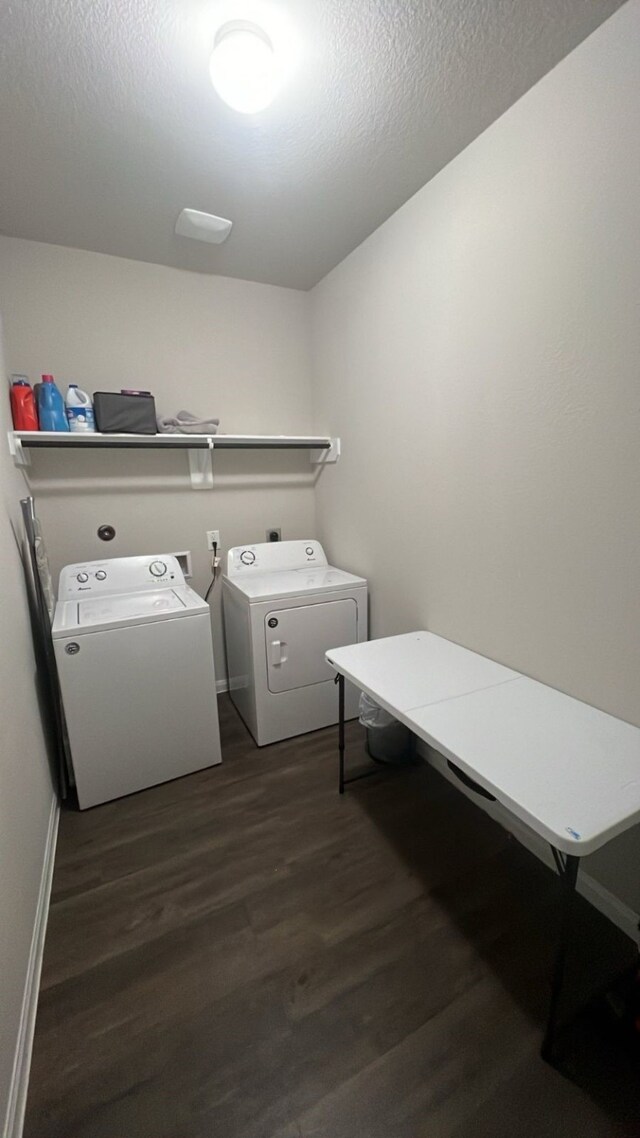 laundry area featuring a textured ceiling, dark hardwood / wood-style flooring, and separate washer and dryer