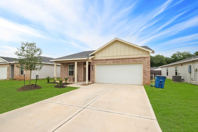 view of front of home with a garage, central AC, and a front lawn