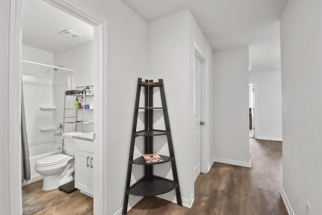 full bathroom with toilet, hardwood / wood-style floors, vanity, and tub / shower combination