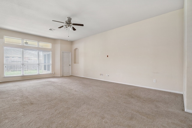 empty room featuring carpet floors and ceiling fan