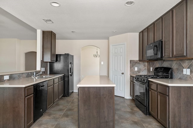 3019 Fern Brook Ln, Rosenberg, TX 77471 - kitchen featuring black appliances, a center island, arched walkways, decorative backsplash, and recessed lighting