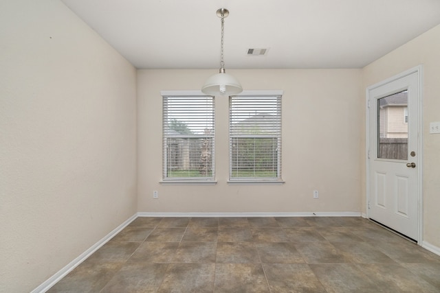 unfurnished dining area featuring tile patterned floors