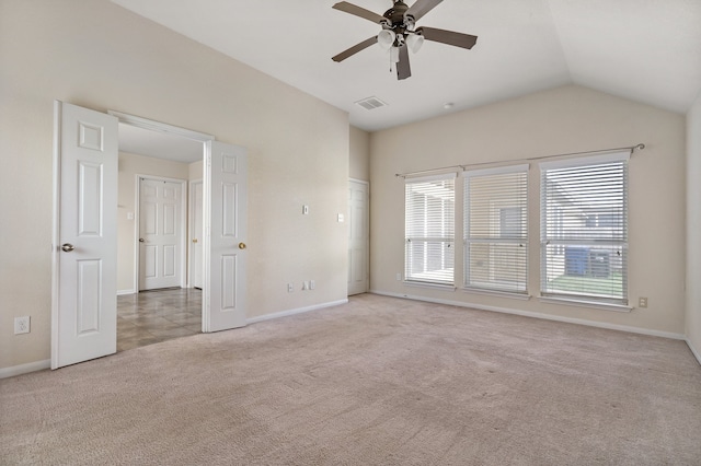 empty room featuring lofted ceiling, carpet floors, and ceiling fan