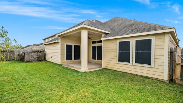 rear view of house featuring a patio area, a yard, and ceiling fan