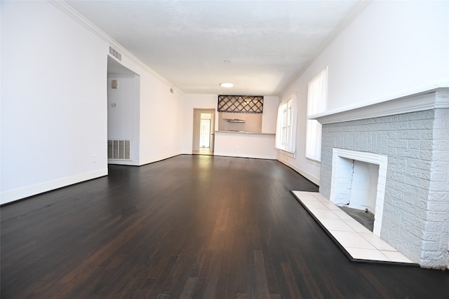 unfurnished living room featuring ornamental molding, a fireplace, and dark wood-type flooring